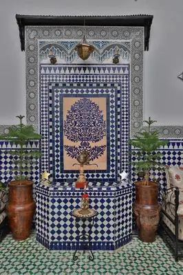 a room with a wall with blue and white tiles at DAR EL AAMOURI in Fès