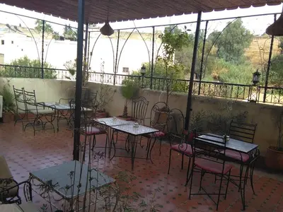 a group of tables and chairs on a patio at DAR EL AAMOURI in Fès