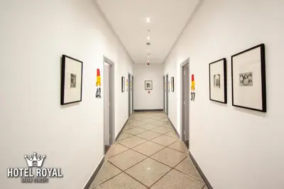a hallway of a hotel room with paintings on the walls at Hôtel Royal Urban Concept in Fès