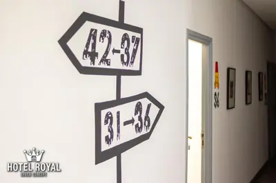 a group of signs hanging on a wall at Hôtel Royal Urban Concept in Fès