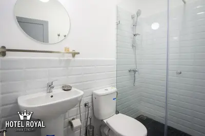 a bathroom with a toilet and a sink and a mirror at Hôtel Royal Urban Concept in Fès