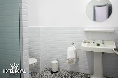 a bathroom with a sink and a toilet and a mirror at Hôtel Royal Urban Concept in Fès