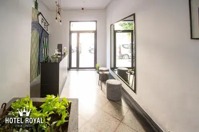 a hallway with a hotel lobby with a mirror at Hôtel Royal Urban Concept in Fès