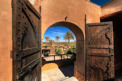 an entrance to a house with an open door at kasbah 123 soleil in Skoura