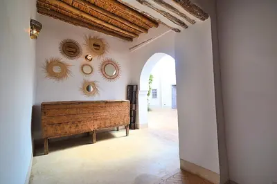 a hallway with a bench and mirrors on the wall at La Villa douce in Marrakech