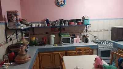 a kitchen with a stove and a microwave at Maroc Galacx in Ouarzazate