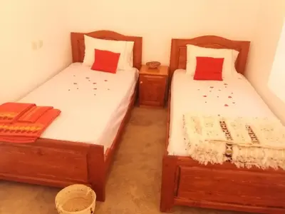 two beds sitting next to each other in a room at ZEN ECOLODGE in Tighli