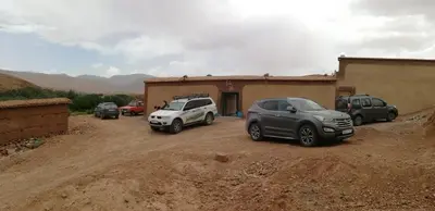 a group of cars parked in front of a building at ZEN ECOLODGE in Tighli
