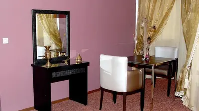 a room with a desk and a mirror and a chair at HOTEL CONTINENTAL Khénifra in Khenifra