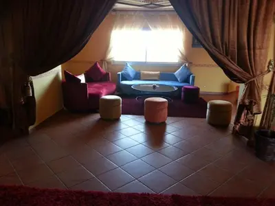 a living room with a blue couch and some chairs at HOTEL CONTINENTAL Khénifra in Khenifra