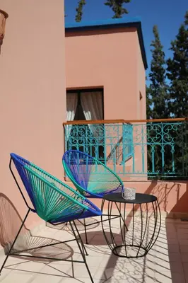 two chairs and a table on a balcony at Tiguemine Sarah in Marrakech