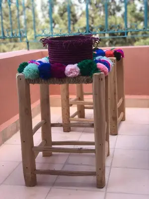 a wooden chair with a basket on top of it at Tiguemine Sarah in Marrakech