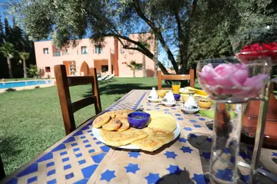 a table with a plate of bread and cookies on it at Tiguemine Sarah in Marrakech