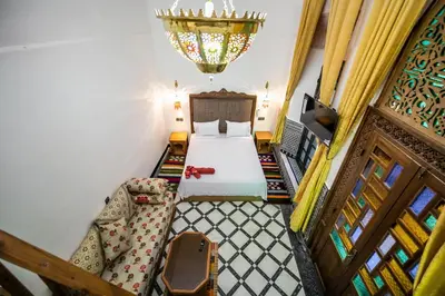 a bedroom with a bed and a couch in a room at Dar Layali Fez in Fès