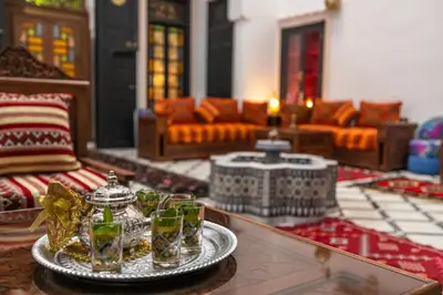 a living room with a table with glasses on it at Dar Layali Fez in Fès