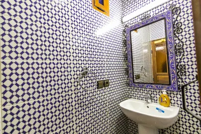 a bathroom with a sink and a mirror at Dar Layali Fez in Fès