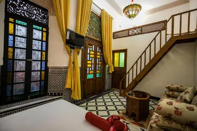 a living room with a couch and a staircase at Dar Layali Fez in Fès