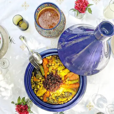 a table topped with a bowl of food with a pot at Jenan Mayshad Marrakech, Luxurious Private Domaine with Pool and Padel Court in Marrakech