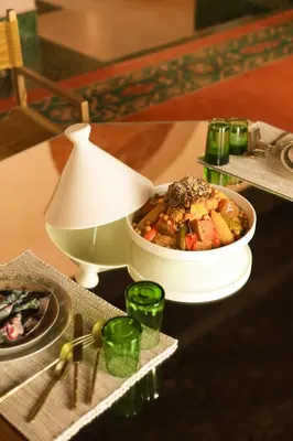 a table with a bowl of food and a lamp at Jenan Mayshad Marrakech, Luxurious Private Domaine with Pool and Padel Court in Marrakech