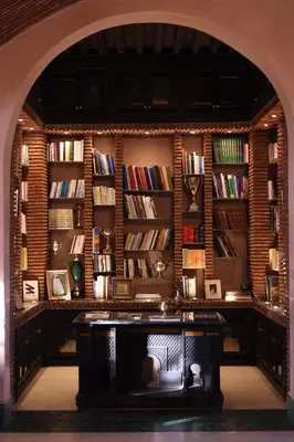 an archway in a room with a library with books at Jenan Mayshad Marrakech, Luxurious Private Domaine with Pool and Padel Court in Marrakech