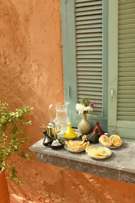 a table with plates of food on a window sill at Jenan Mayshad Marrakech, Luxurious Private Domaine with Pool and Padel Court in Marrakech