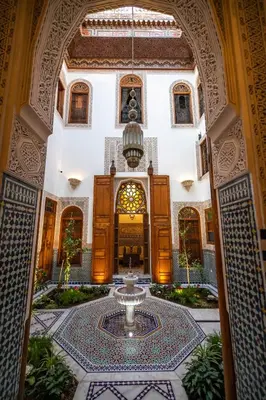 a building with a fountain in the middle of a courtyard at Riad Sidrat Fes in Fès