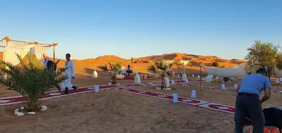 a group of people standing in the desert at Nomads Dunes Nest in Merzouga