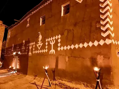 a building with lights on the side of it at Riad Assia Foum Zguid in Foum Zguid