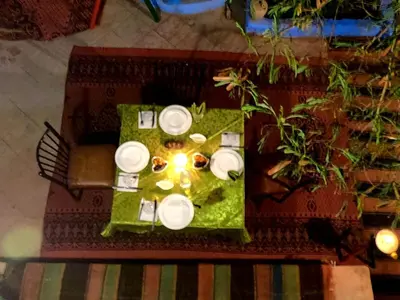 an overhead view of a table with plates and candles at Riad Assia Foum Zguid in Foum Zguid