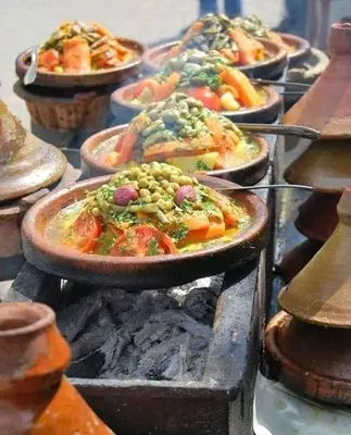 a bunch of dishes of food on a grill at Riad Assia Foum Zguid in Foum Zguid