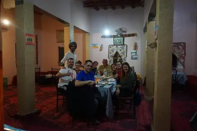 a group of people sitting at a table in a room at Riad Assia Foum Zguid in Foum Zguid