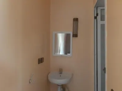 a bathroom with a sink and a mirror on the wall at Guests House in Merzouga