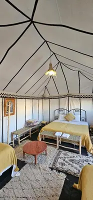 a room with two beds in a tent at Sun Bivouac Chegaga in El Gouera