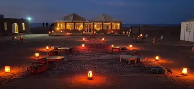 a house with candles in front of it at night at Sun Bivouac Chegaga in El Gouera
