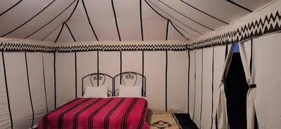 a room with a bed in a tent at Sun Bivouac Chegaga in El Gouera