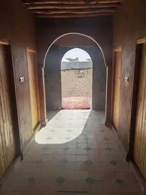 an empty hallway with an archway in a building at Sun Bivouac Chegaga in El Gouera