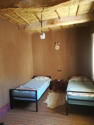 a room with two beds in a room at Gite Amoudou in Ouarzazate