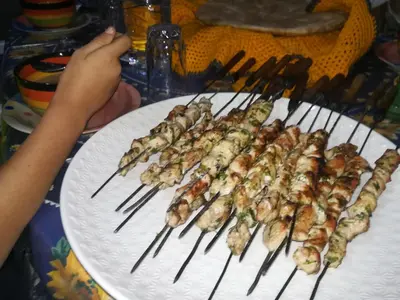a bunch of skewers of food on a plate at Gite Amoudou in Ouarzazate