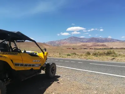 a yellow atv parked on the side of a road at Gite Amoudou in Ouarzazate