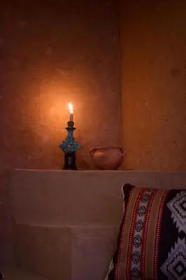 a candle sitting on a mantle with a bowl at Camp Ayour Mhamid in Mhamid