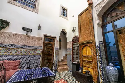 a room with a table and some tiles on the wall at Riad Fes Aicha & SPA in Fès