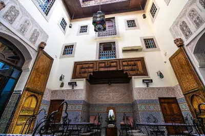 an ornate building with wooden doors and windows at Riad Fes Aicha & SPA in Fès