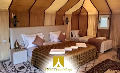 a bedroom with two beds in a room at Superior Desert Camp in Merzouga