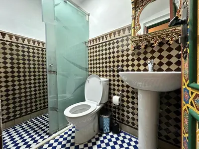 a bathroom with a toilet and a sink at Riad Shama Fes in Fès