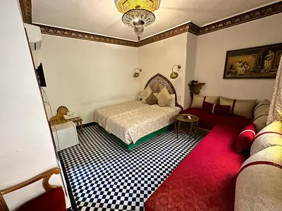 a bedroom with a bed and a couch at Riad Shama Fes in Fès