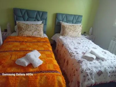 a bedroom with two beds with towels on them at Gîte Forest Tagroumte in Azrou