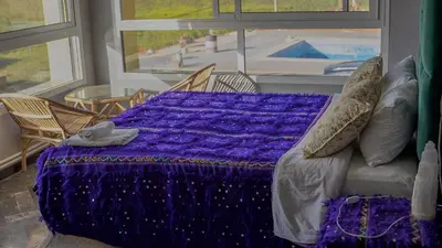 a purple bed in a room with a window at Gîte Forest Tagroumte in Azrou