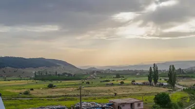 a view of a field with mountains in the background at Gîte Forest Tagroumte in Azrou