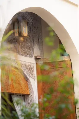 a close up of a door with a light on it at Riad Al Ansari in Fès