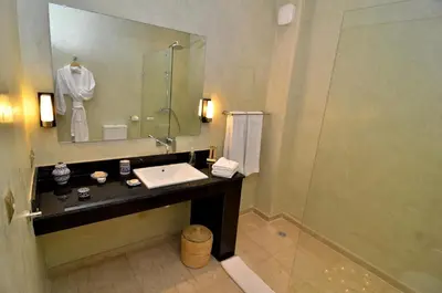 a bathroom with a sink and a mirror at Riad Al Ansari in Fès